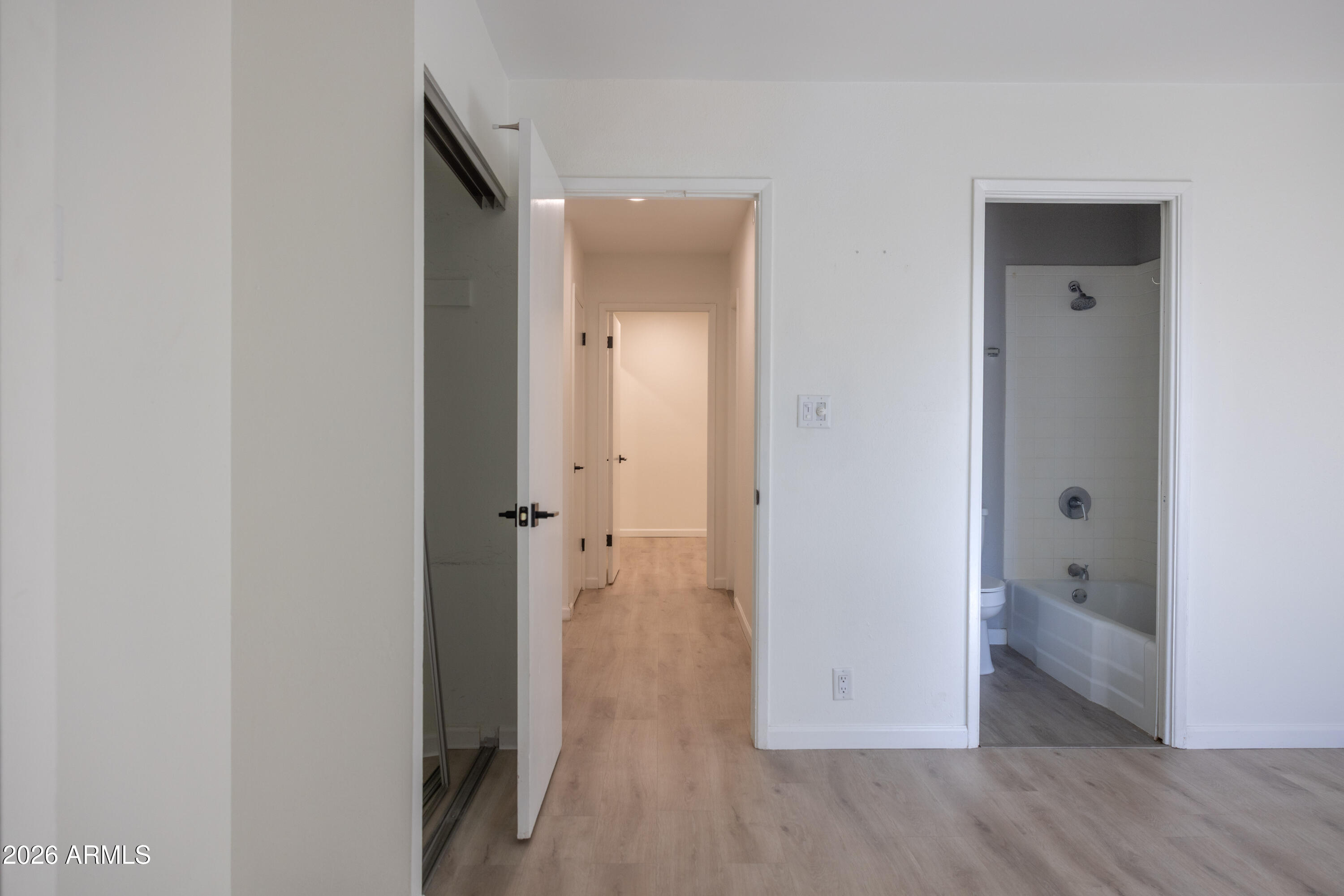 1450 East Bethany Home Road, Unit 31 Phoenix, AZ 85014 - Photo 10 of 24 a view of a hallway with wooden floor and closet area
