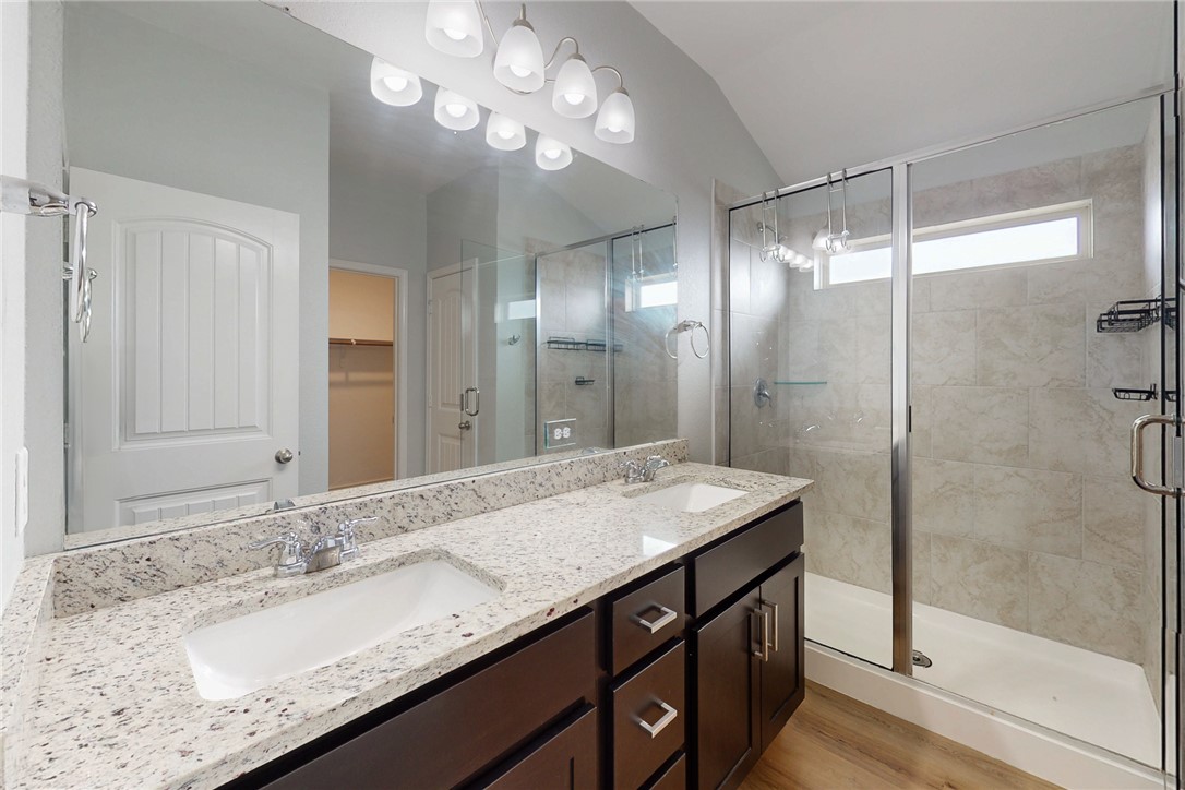 2029 Rock Rdg Avenue Bryan, TX 77807 - Photo 19 of 31 a bathroom with a granite countertop sink a large mirror and shower