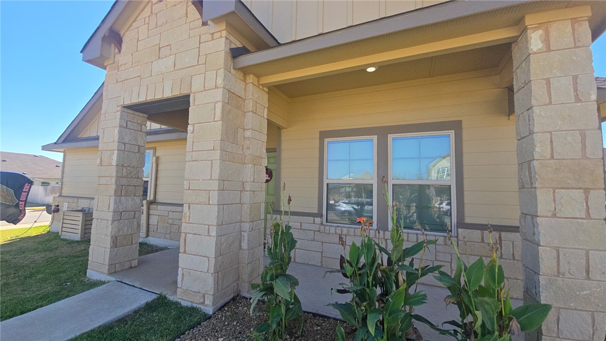 2029 Rock Rdg Avenue Bryan, TX 77807 - Photo 3 of 31 a view of a brick house with a potted plant ana a small yard