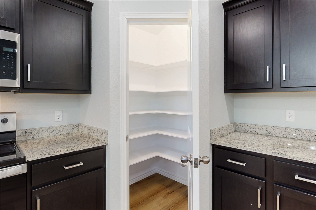 2029 Rock Rdg Avenue Bryan, TX 77807 - Photo 8 of 31 a view of a kitchen with a sink and cabinets