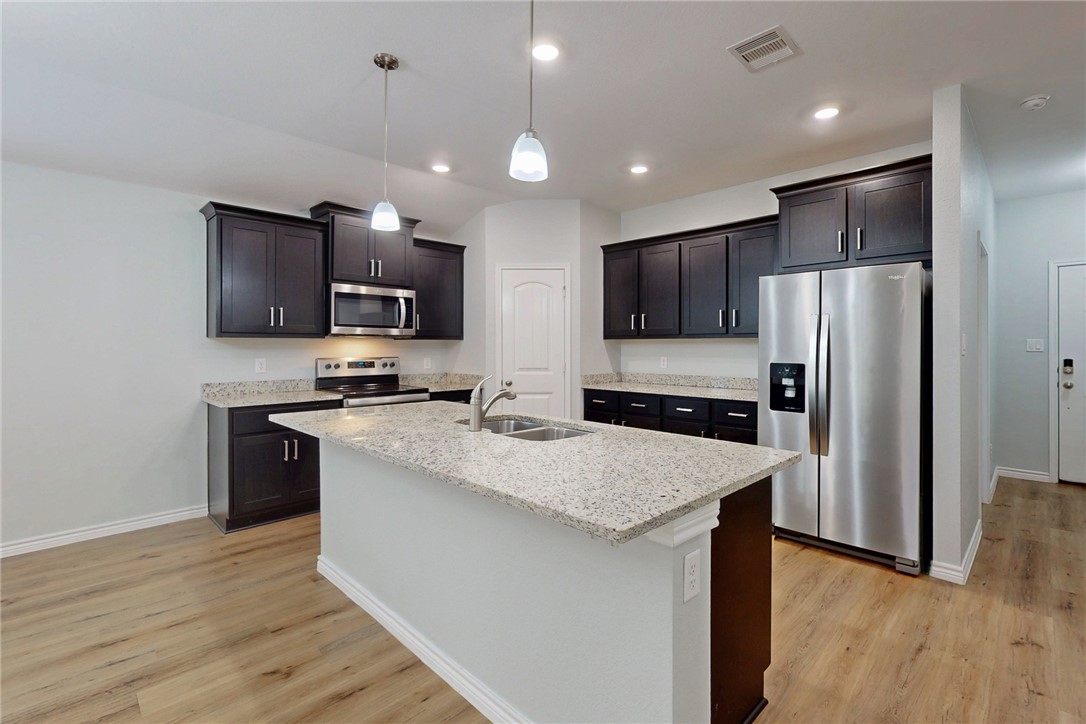 2029 Rock Rdg Avenue Bryan, TX 77807 - Photo 9 of 31 a kitchen with stainless steel appliances granite countertop a refrigerator stove microwave and sink
