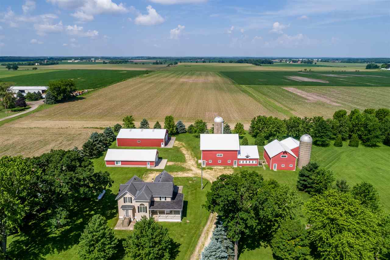 a aerial view of a house with a garden and a swimming pool