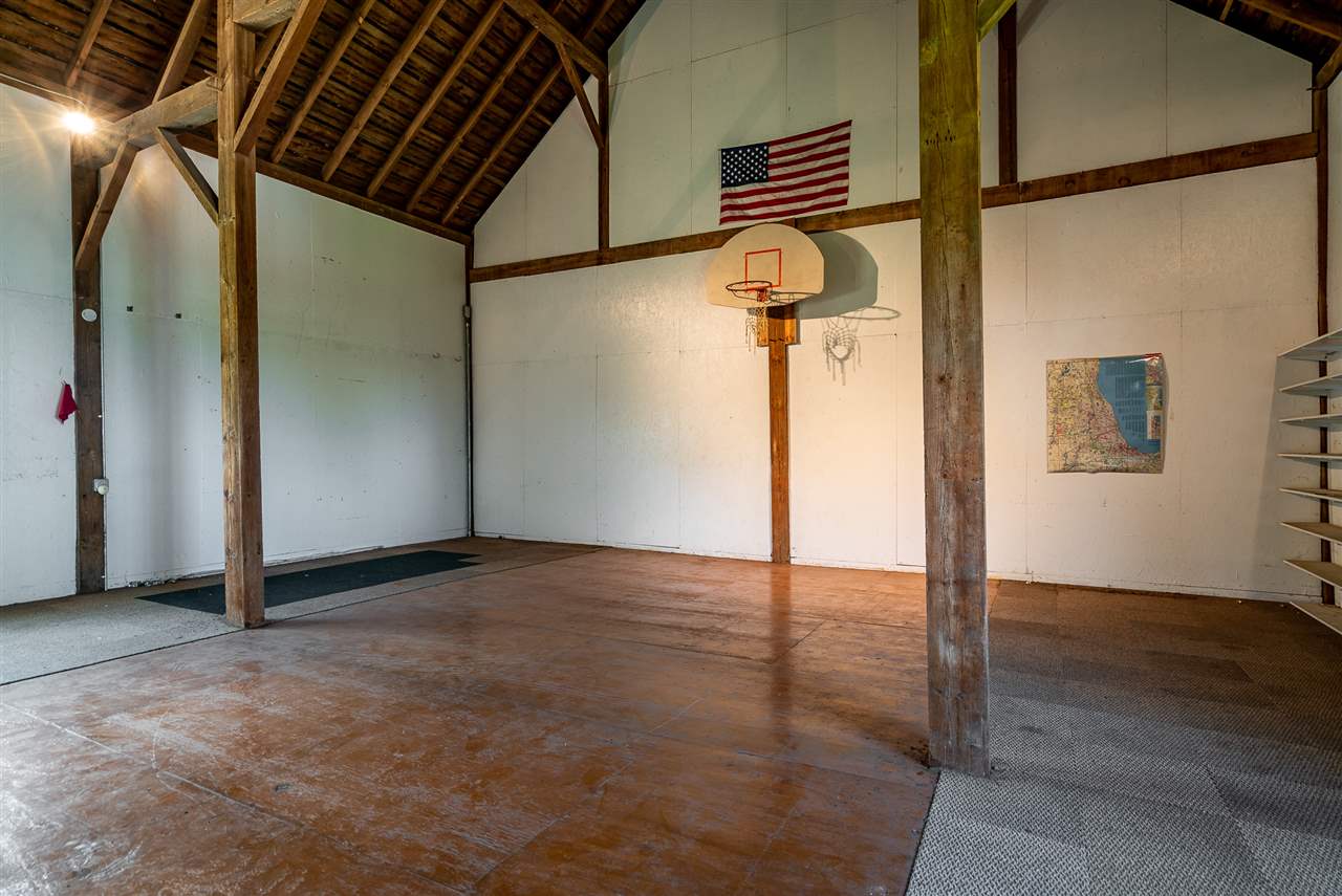 16602 Wyman School Road Caledonia, IL 61011 - Photo 14 of 25 an empty room with wooden floor and windows