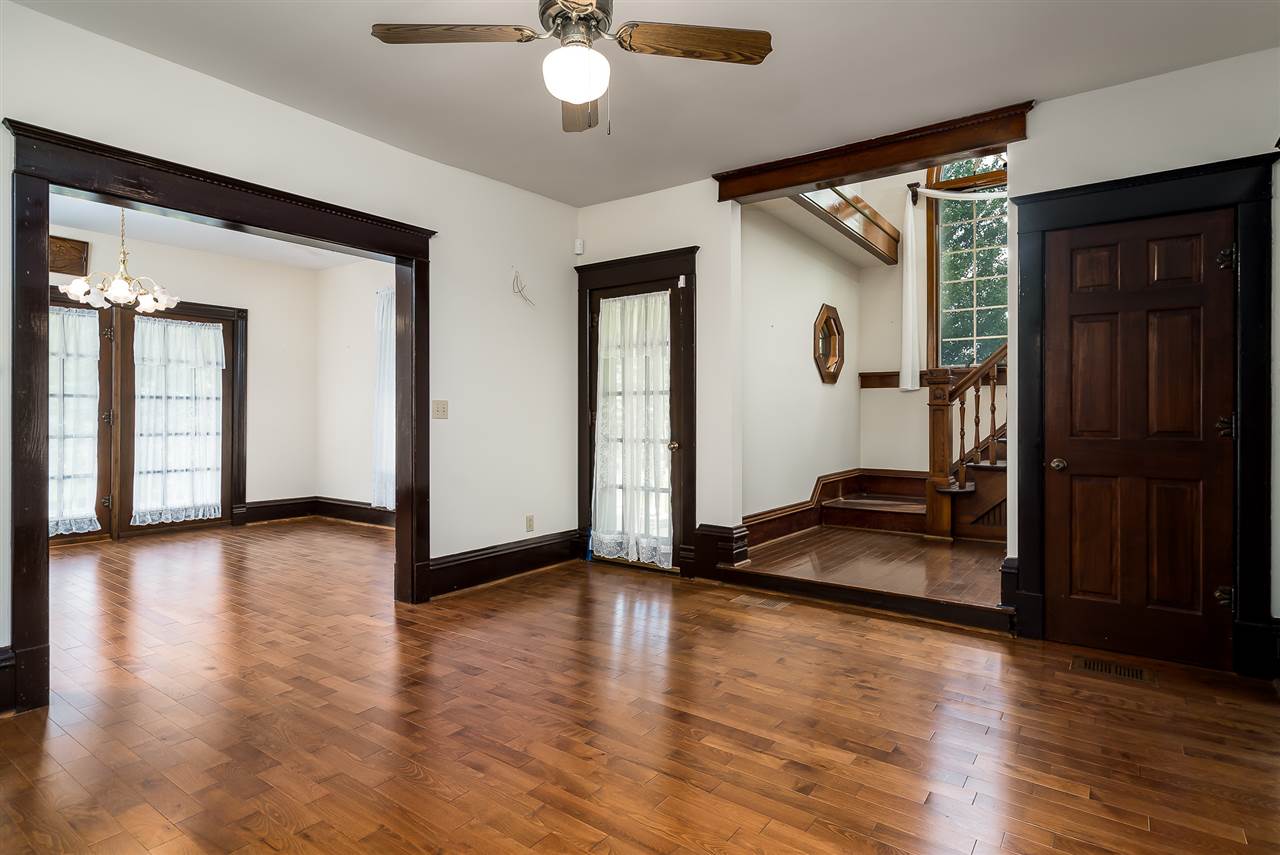 16602 Wyman School Road Caledonia, IL 61011 - Photo 24 of 25 a view of a livingroom with wooden floor and a ceiling fan