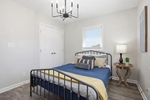 a bedroom with a bed and a chandelier