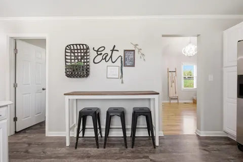 a living room with a table and chairs