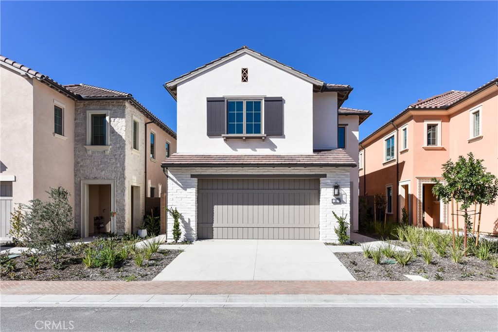141 Statura Irvine, CA 92602 - Photo 1 of 1 a front view of a house with garage and plants