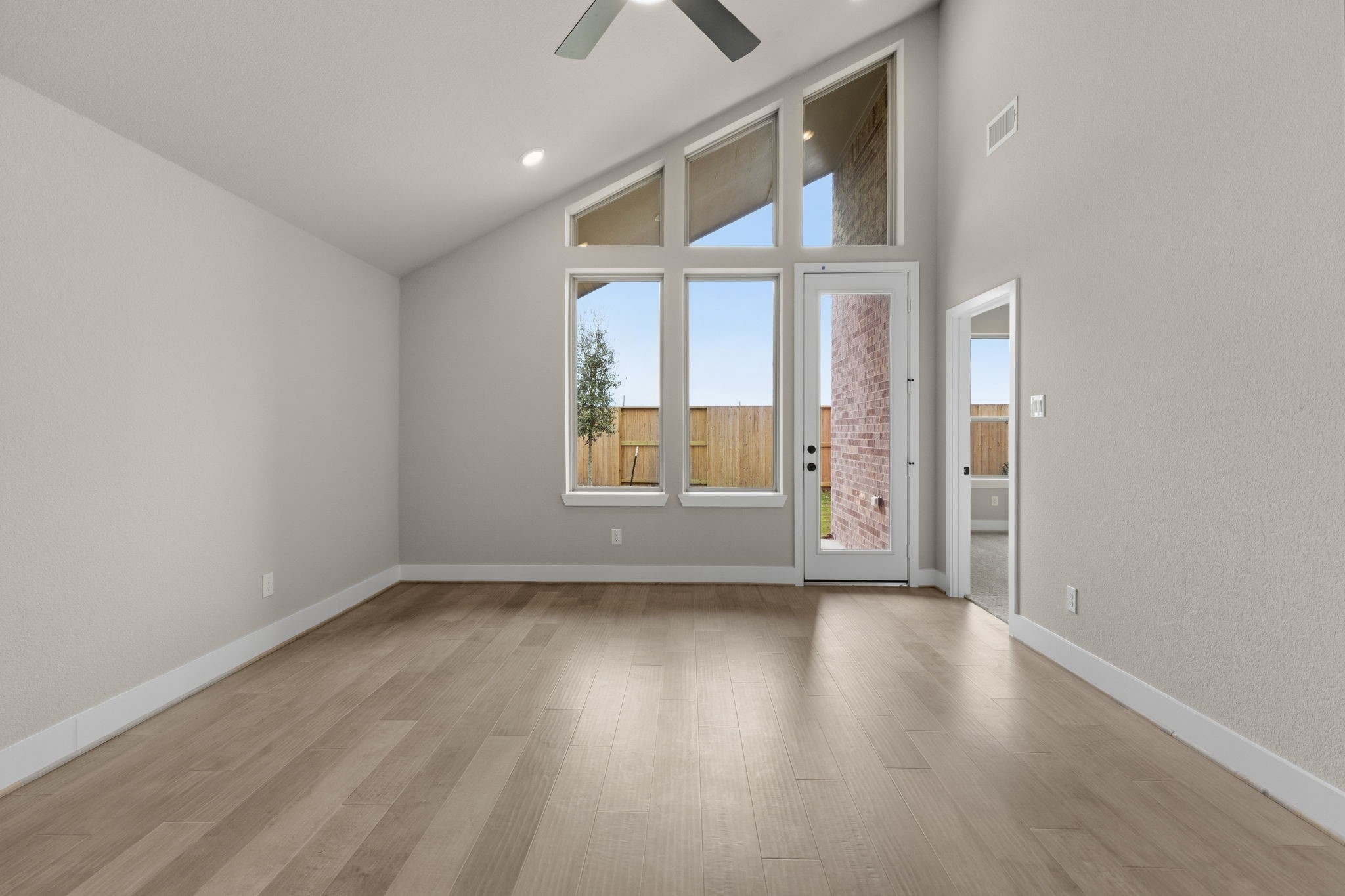 5210 Getty Lane Iowa Colony, TX 77578 - Photo 11 of 34 an empty room with wooden floor and windows