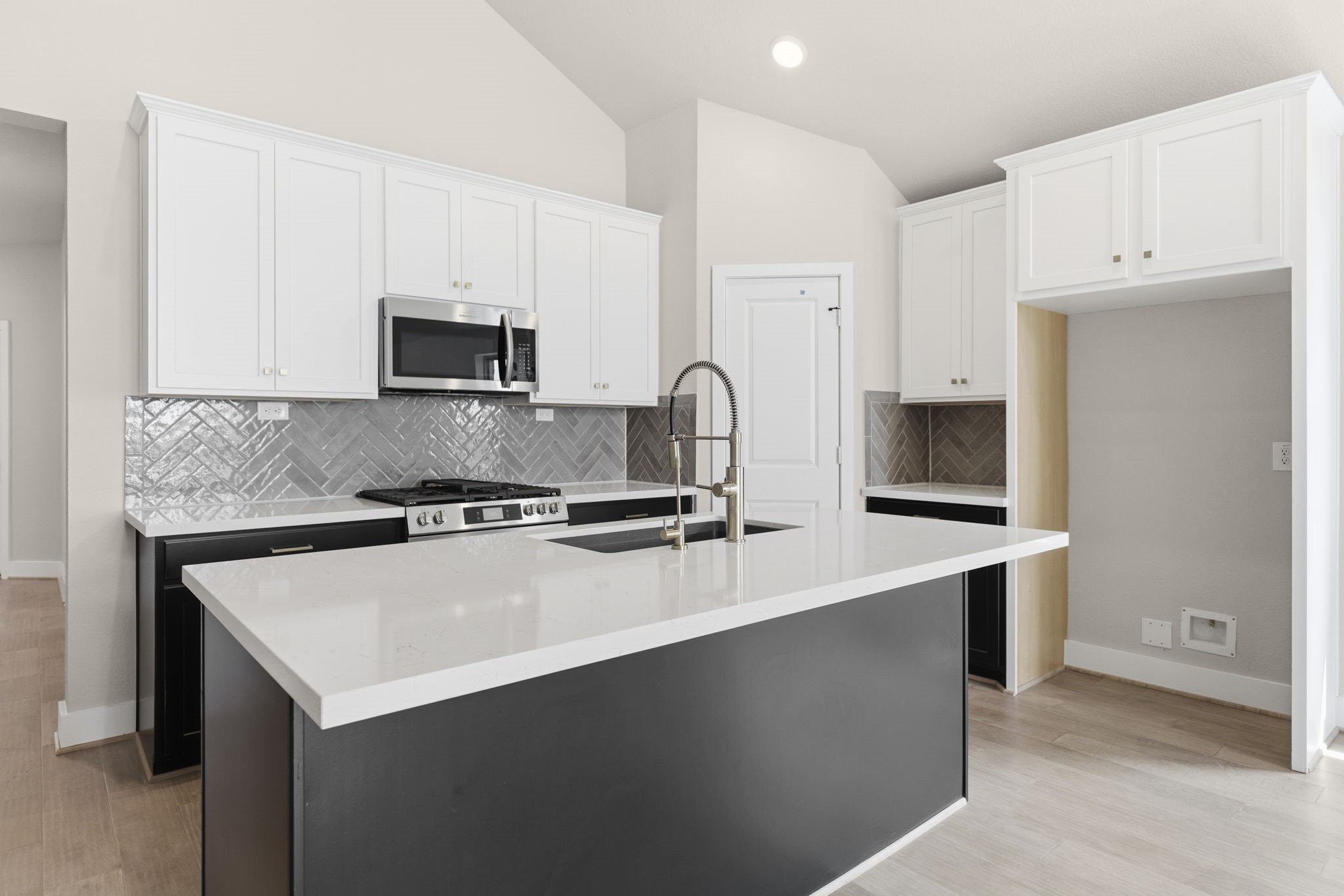 5210 Getty Lane Iowa Colony, TX 77578 - Photo 15 of 34 a kitchen with stainless steel appliances a sink a stove a microwave a sink a refrigerator and cabinets