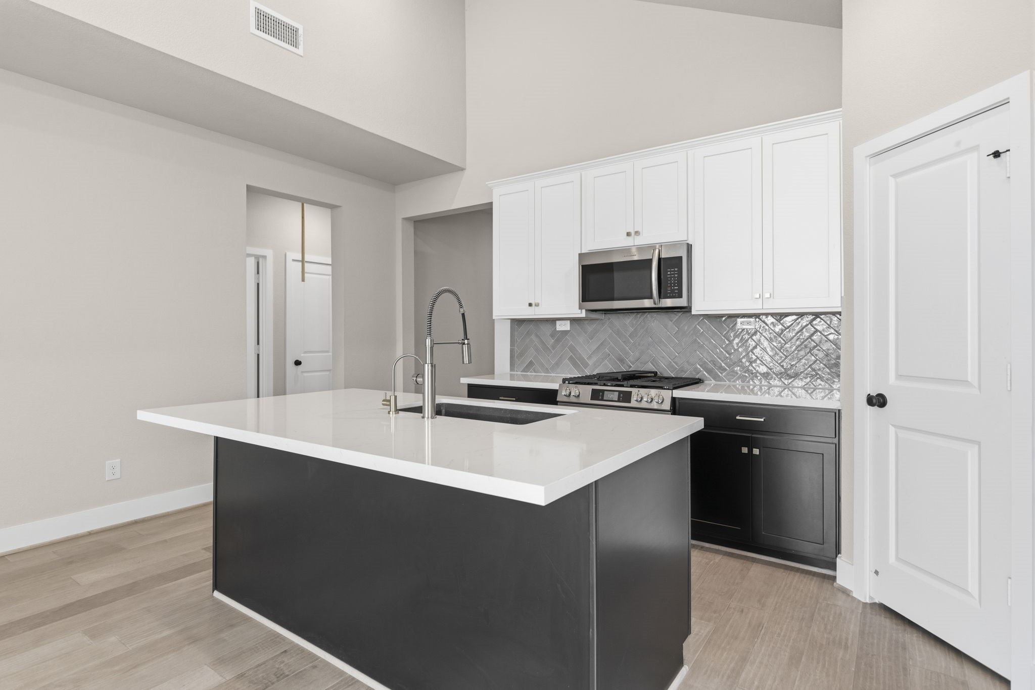 5210 Getty Lane Iowa Colony, TX 77578 - Photo 16 of 34 a kitchen with a sink stove and microwave