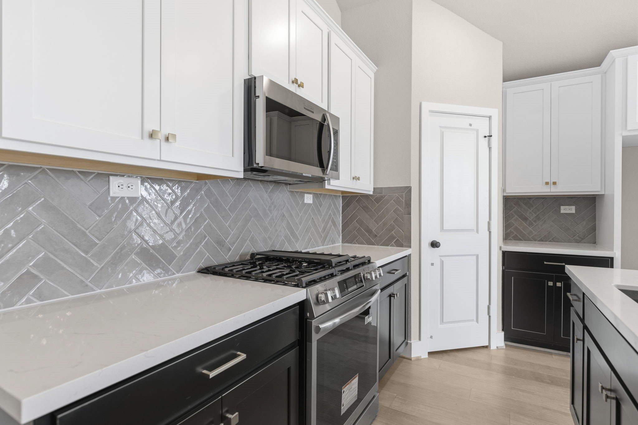5210 Getty Lane Iowa Colony, TX 77578 - Photo 17 of 34 a kitchen with stainless steel appliances a stove a microwave a sink and cabinets