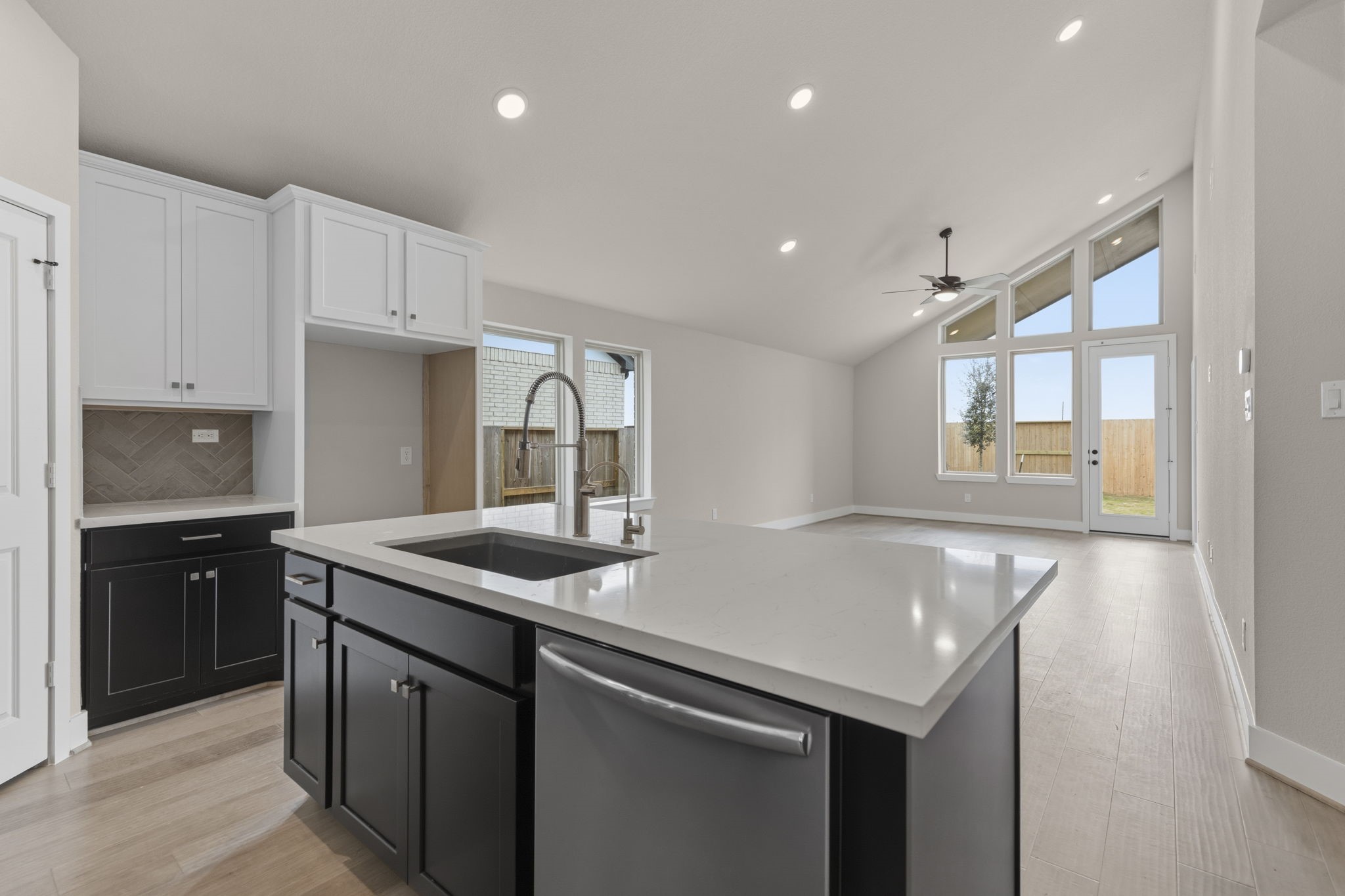 5210 Getty Lane Iowa Colony, TX 77578 - Photo 18 of 34 a kitchen with stainless steel appliances granite countertop a sink and dishwasher with white cabinets