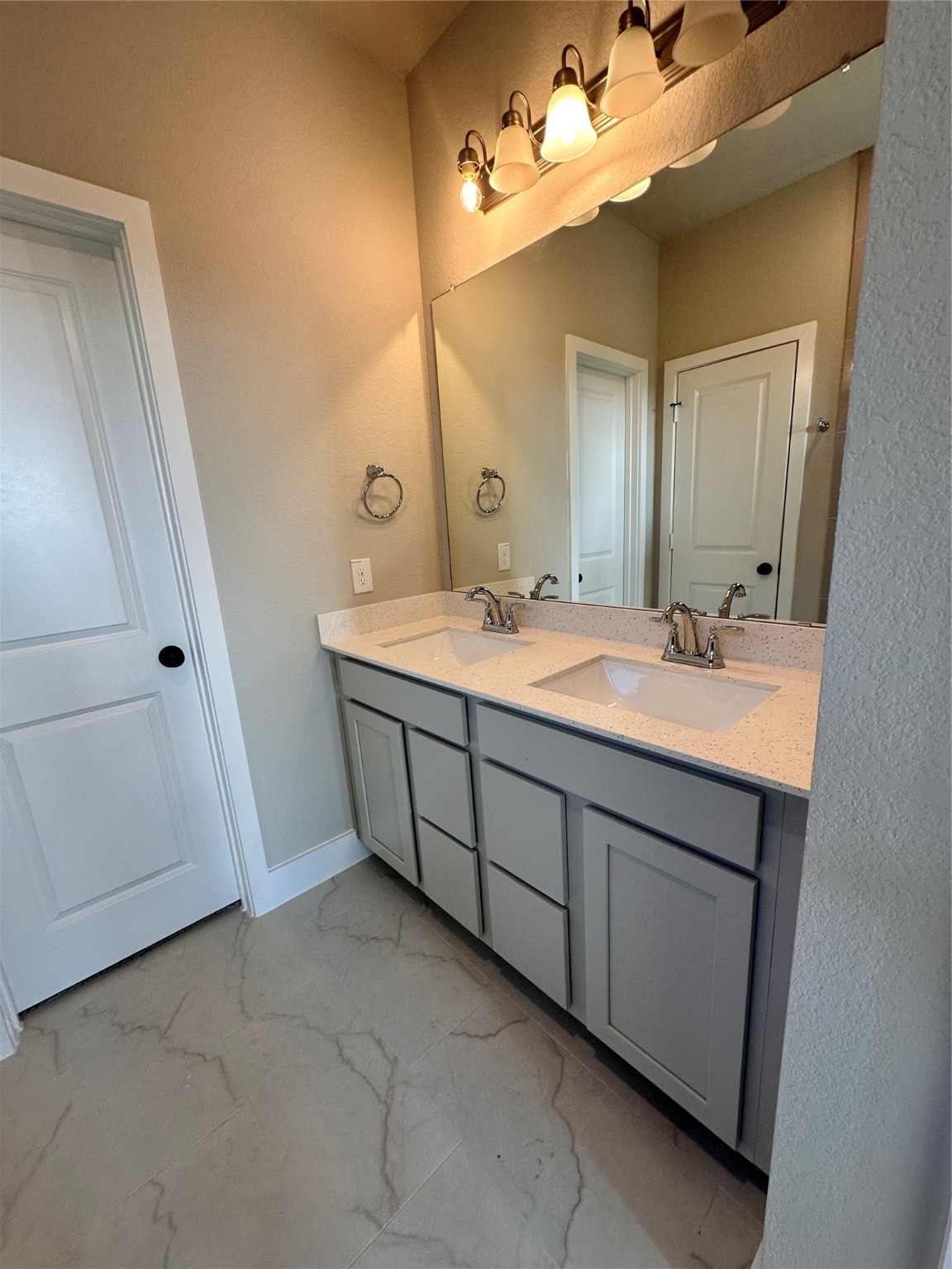 5210 Getty Lane Iowa Colony, TX 77578 - Photo 2 of 30 a spacious bathroom with a double vanity sink a mirror and a