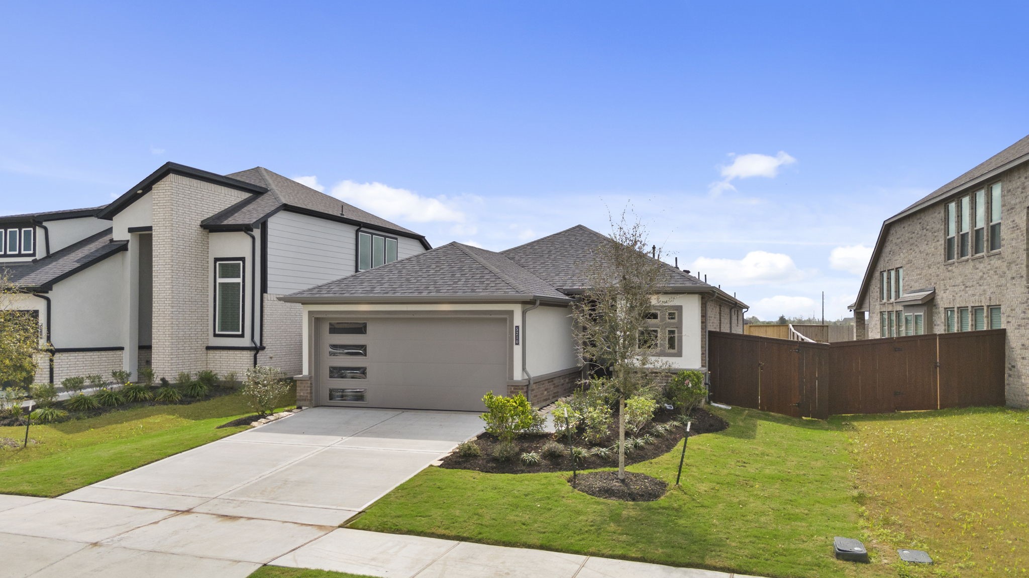 5210 Getty Lane Iowa Colony, TX 77578 - Photo 2 of 34 a front view of a house with a yard and garage