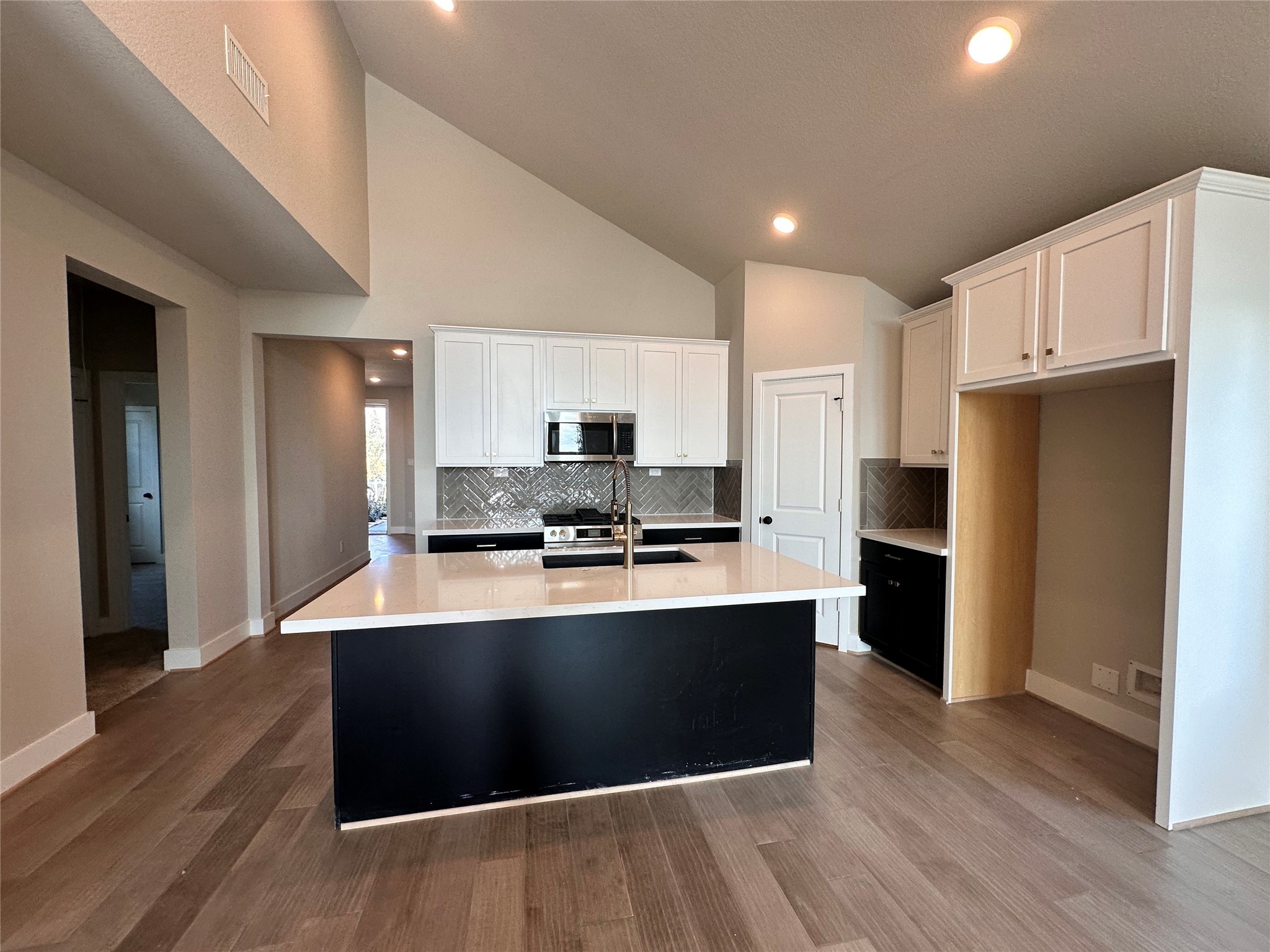 5210 Getty Lane Iowa Colony, TX 77578 - Photo 6 of 30 a large kitchen with stainless steel appliances kitchen island granite countertop a refrigerator and a stove top oven