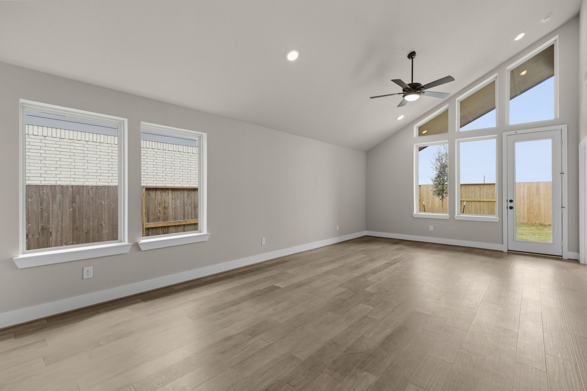 5210 Getty Lane Iowa Colony, TX 77578 - Photo 10 of 34 a view of an empty room with a window and wooden floor