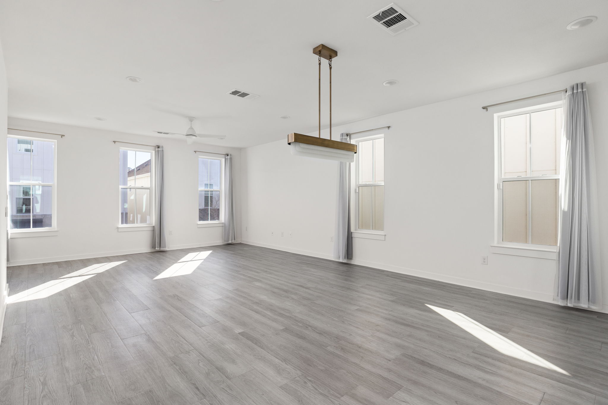 2624 Metcalfe Road, Unit 17 Austin, TX 78741 - Photo 13 of 35 a view of empty room with wooden floor and window