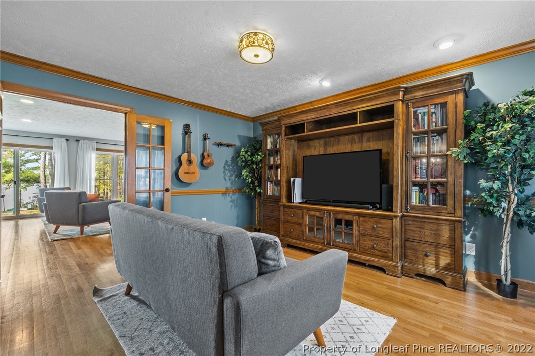 30480 East Lake Road Wagram, NC 28396 - Photo 11 of 49 a living room with furniture and a flat screen tv