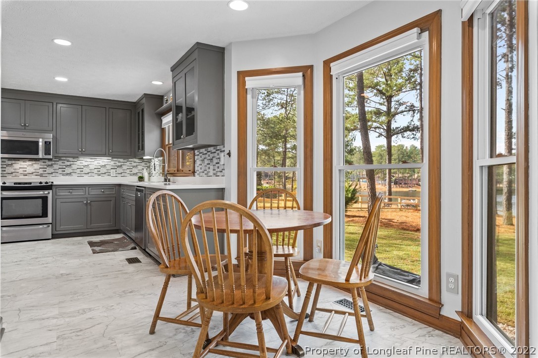 30480 East Lake Road Wagram, NC 28396 - Photo 22 of 49 a dining room with furniture a chandelier and wooden floor