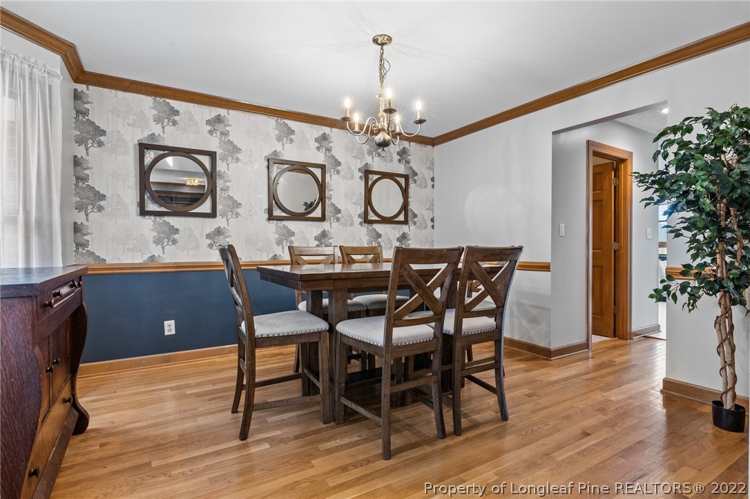30480 East Lake Road Wagram, NC 28396 - Photo 23 of 49 a view of a dining room with furniture and wooden floor