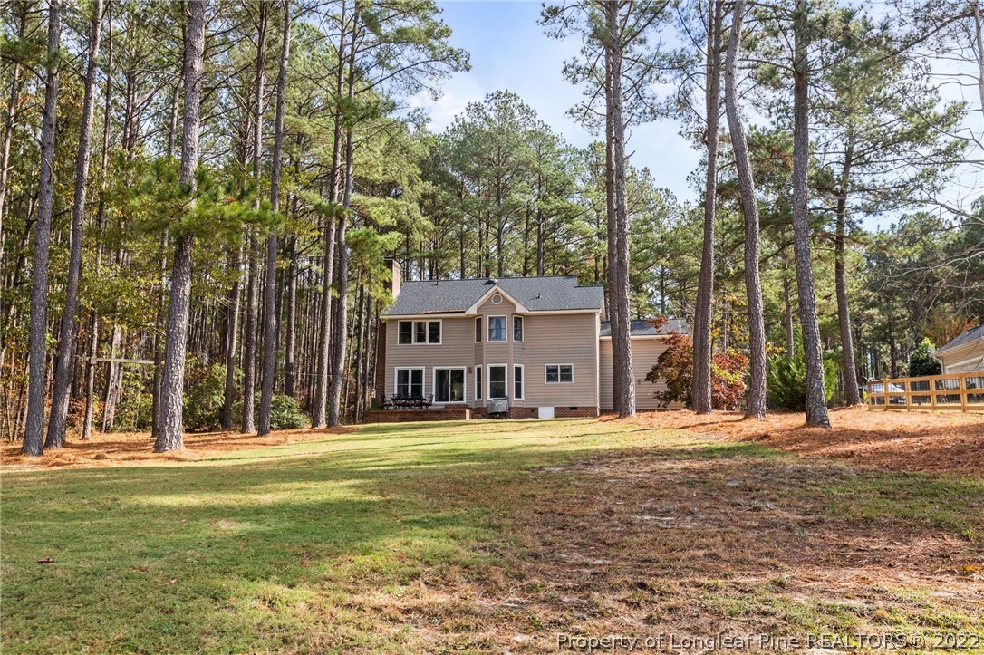 30480 East Lake Road Wagram, NC 28396 - Photo 39 of 49 a large building with trees in front of it