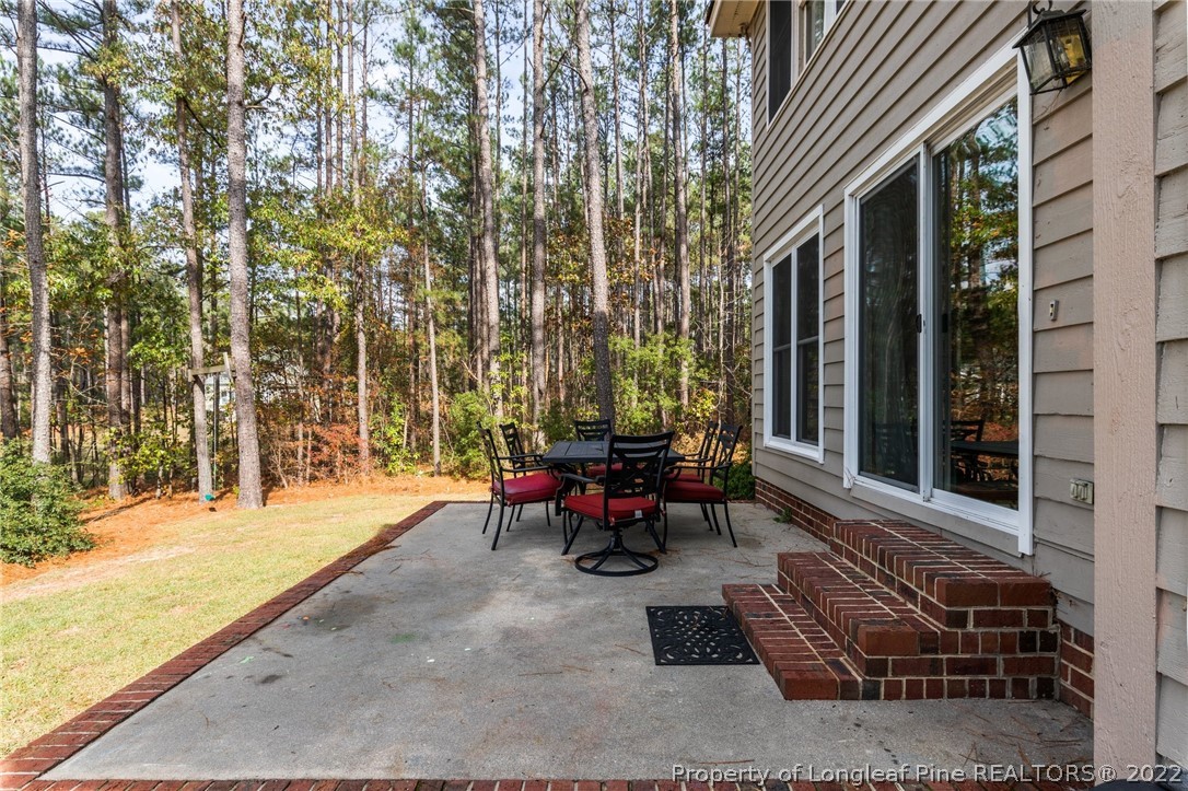 30480 East Lake Road Wagram, NC 28396 - Photo 41 of 49 a backyard of a house with outdoor seating