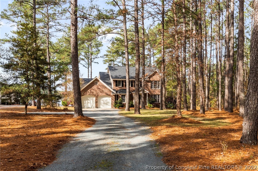 30480 East Lake Road Wagram, NC 28396 - Photo 45 of 49 a house with trees in front of it
