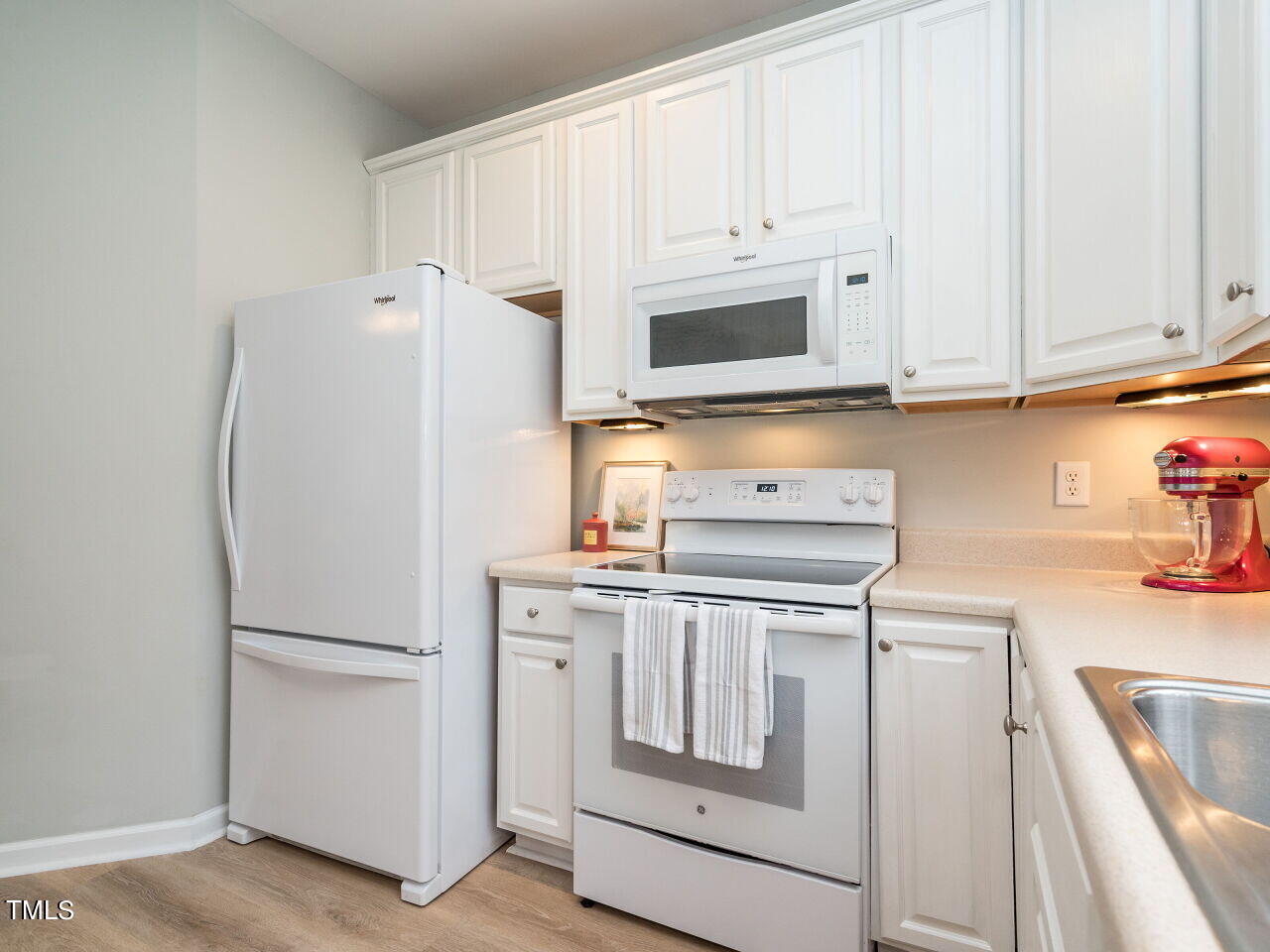 2650 Andover Glen Road Raleigh, NC 27604 - Photo 9 of 27 a kitchen with white cabinets and white appliances