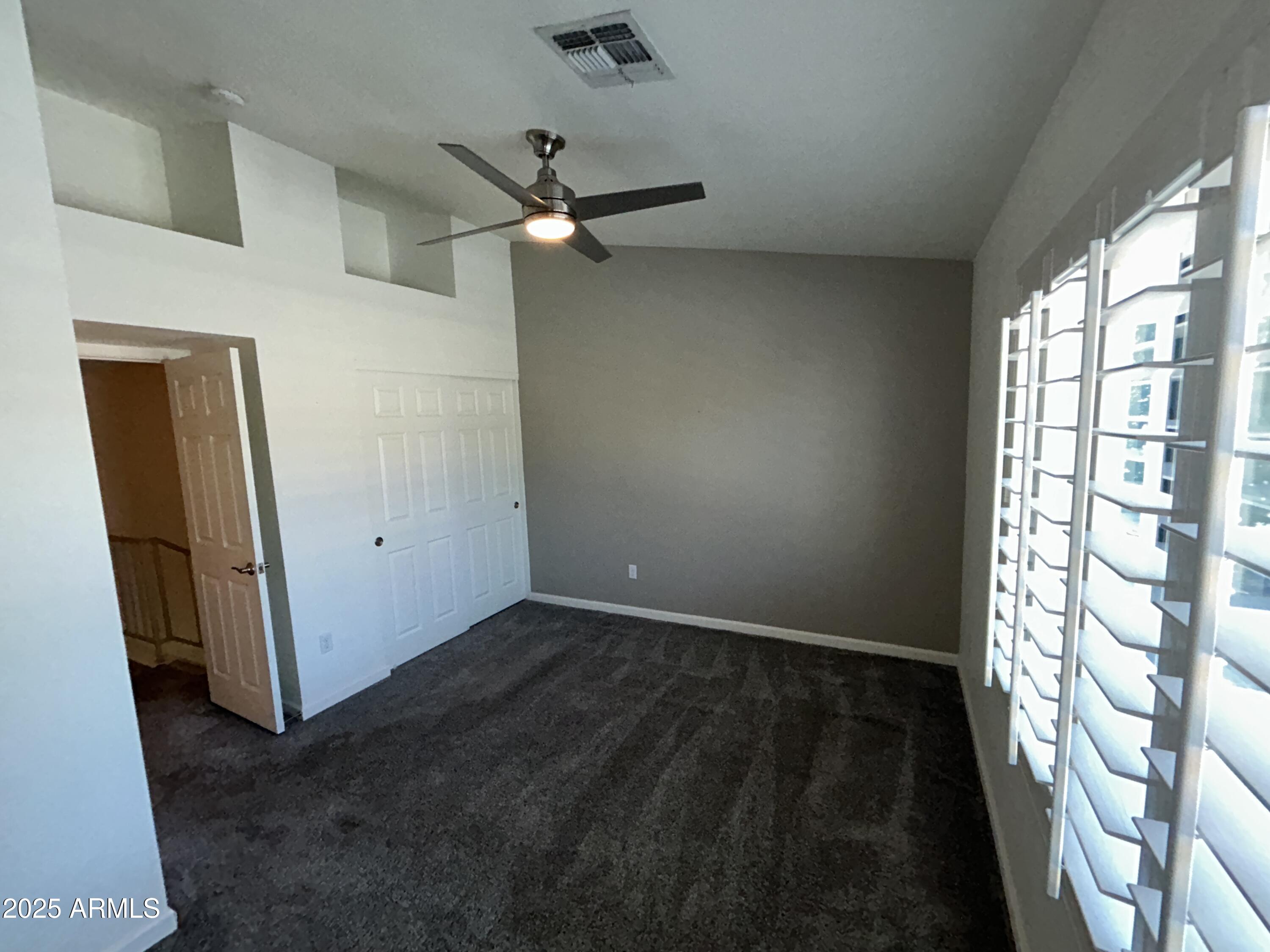 9831 South 48th Way, Unit 4 Phoenix, AZ 85044 - Photo 11 of 21 a view of an empty room with a window