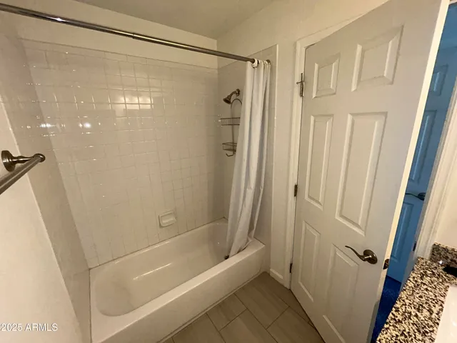 a bathroom with a shower and a bath tub