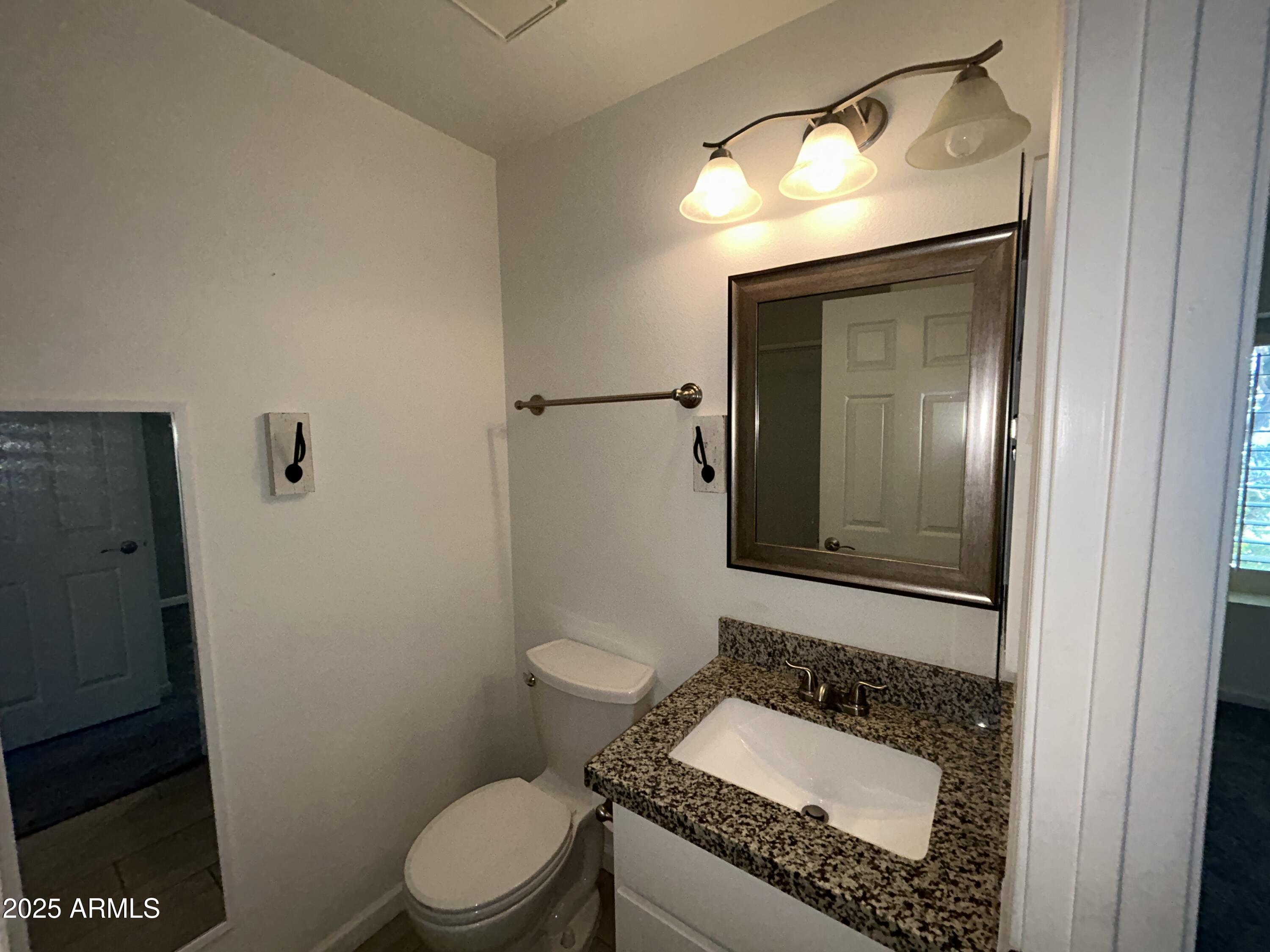 9831 South 48th Way, Unit 4 Phoenix, AZ 85044 - Photo 14 of 21 a bathroom with a granite countertop sink mirror vanity and toilet