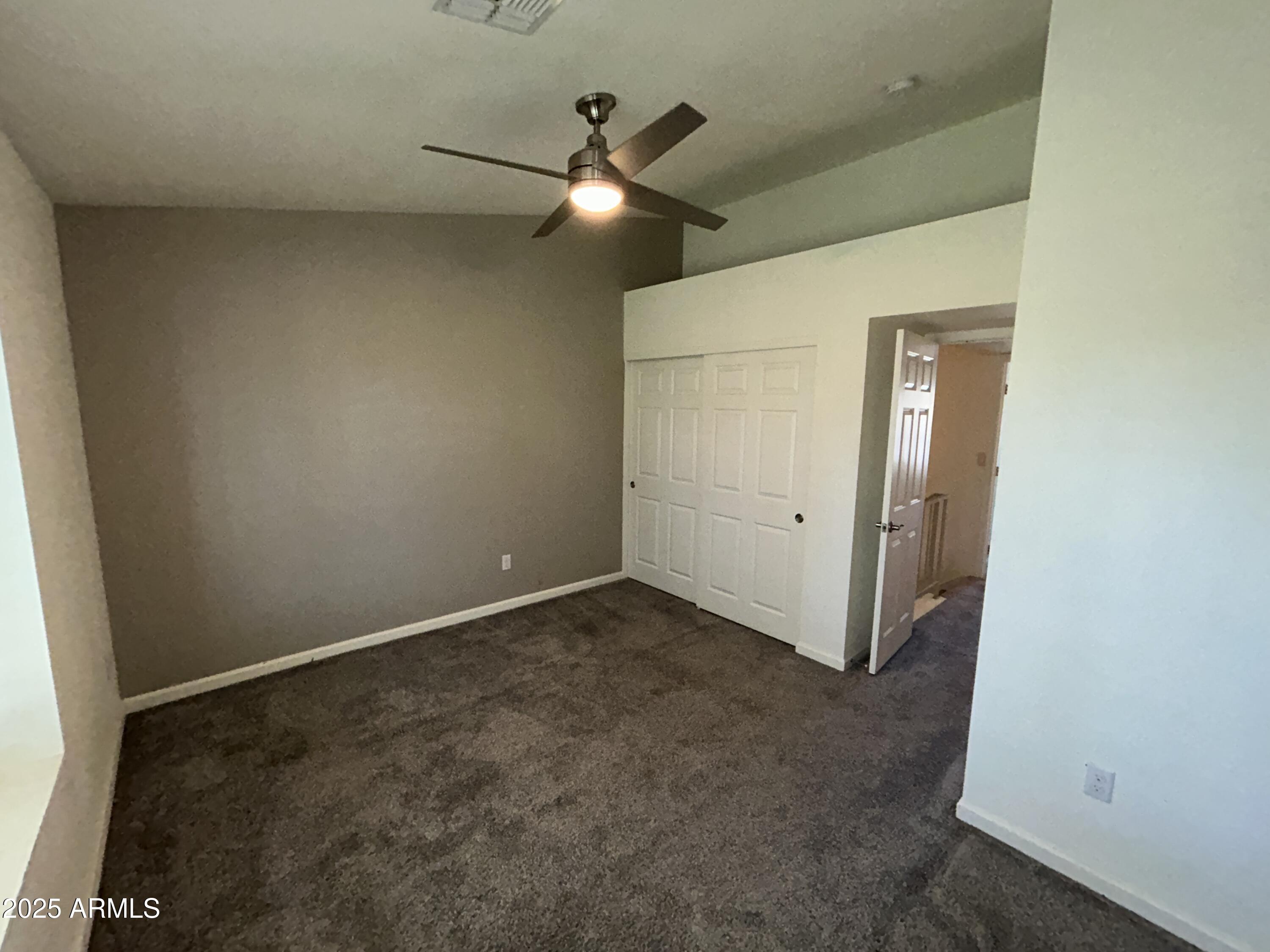 9831 South 48th Way, Unit 4 Phoenix, AZ 85044 - Photo 17 of 21 an empty room with a ceiling fan and a window