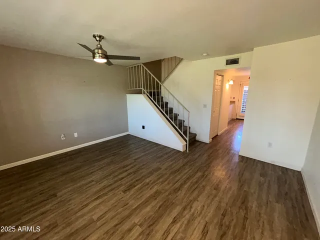 a view of a room with wooden floor and white walls