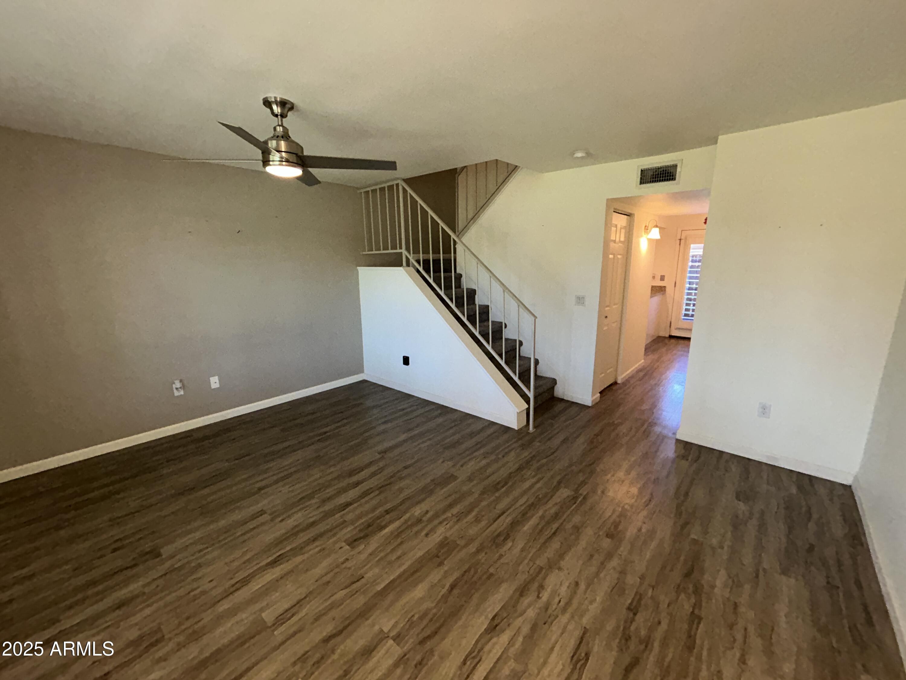 9831 South 48th Way, Unit 4 Phoenix, AZ 85044 - Photo 3 of 21 a view of a room with wooden floor and white walls