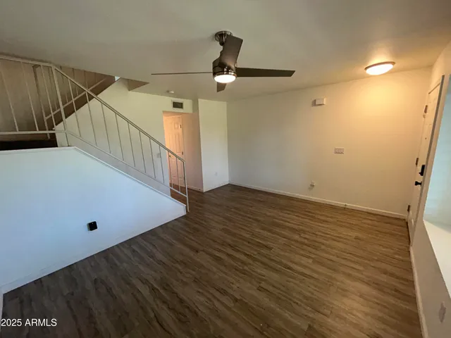 a view of a room with wooden floor