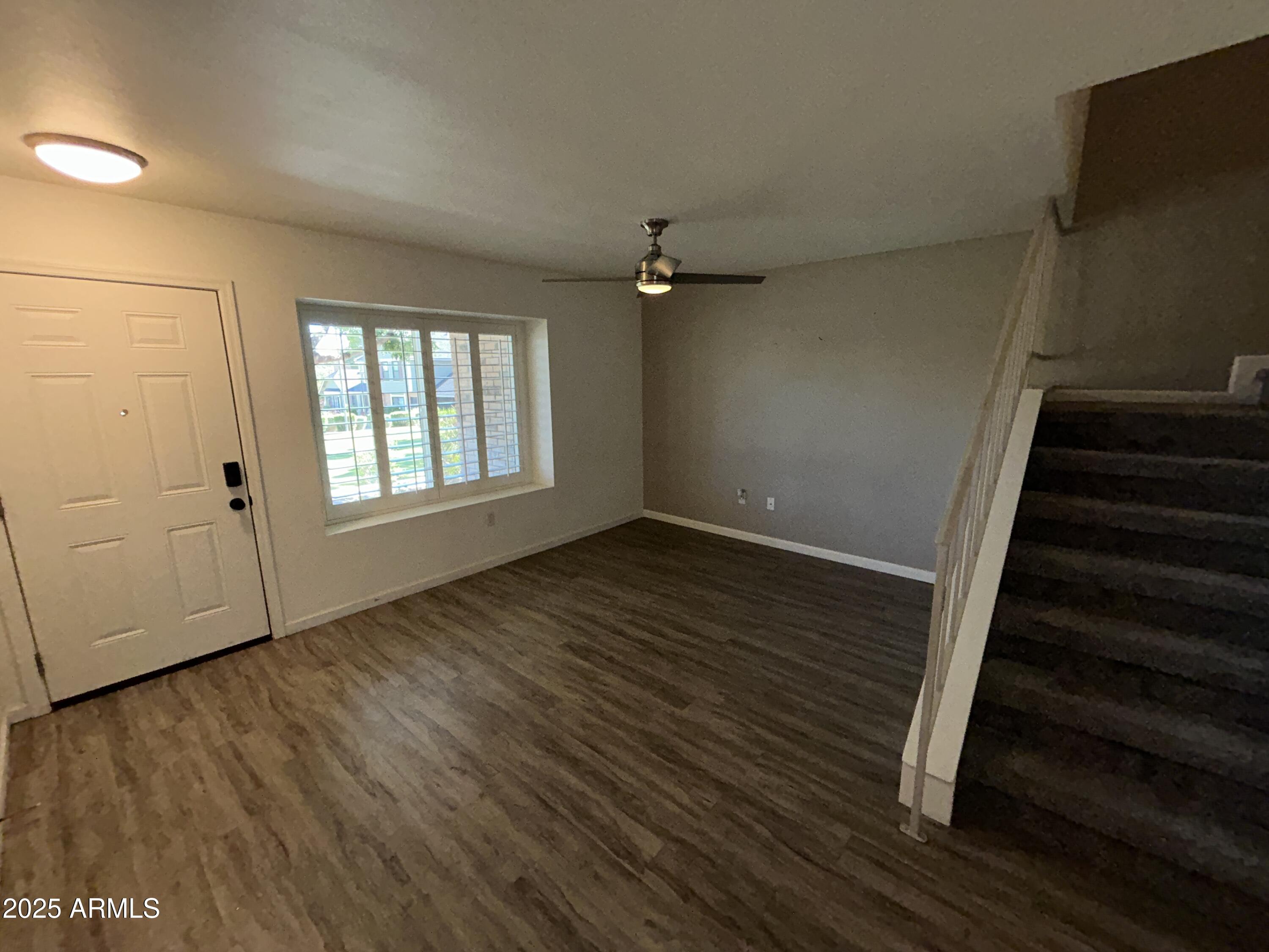 9831 South 48th Way, Unit 4 Phoenix, AZ 85044 - Photo 5 of 21 wooden floor in an empty room with a window