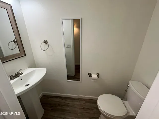 a bathroom with a sink a toilet and mirror