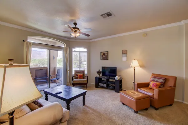 a living room with furniture a table and a large window