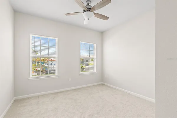 an empty room with a empty space and a ceiling fan