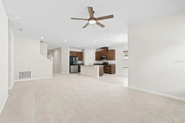 a view of kitchen with furniture and stainless steel appliances