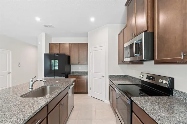 a kitchen that has a sink and a stove