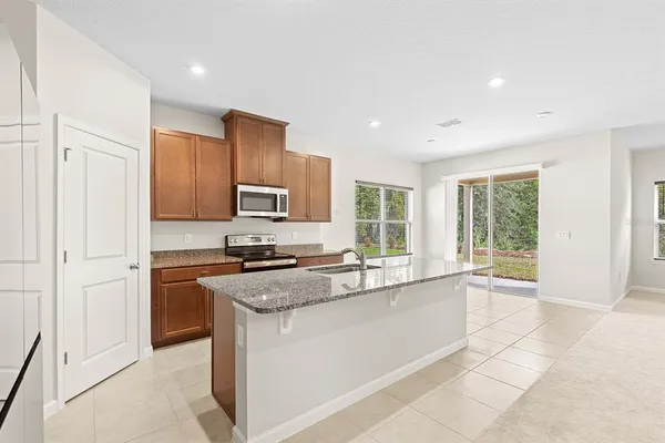 a kitchen with a stove a sink and a refrigerator