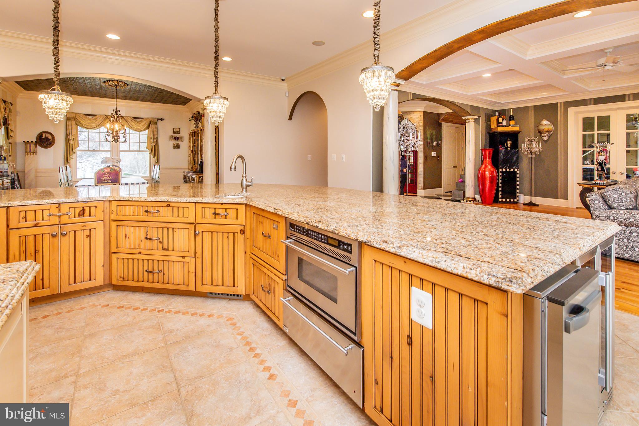 211 Norwood Road Annapolis, MD 21401 - Photo 23 of 94 a large kitchen with granite countertop a sink and white cabinets