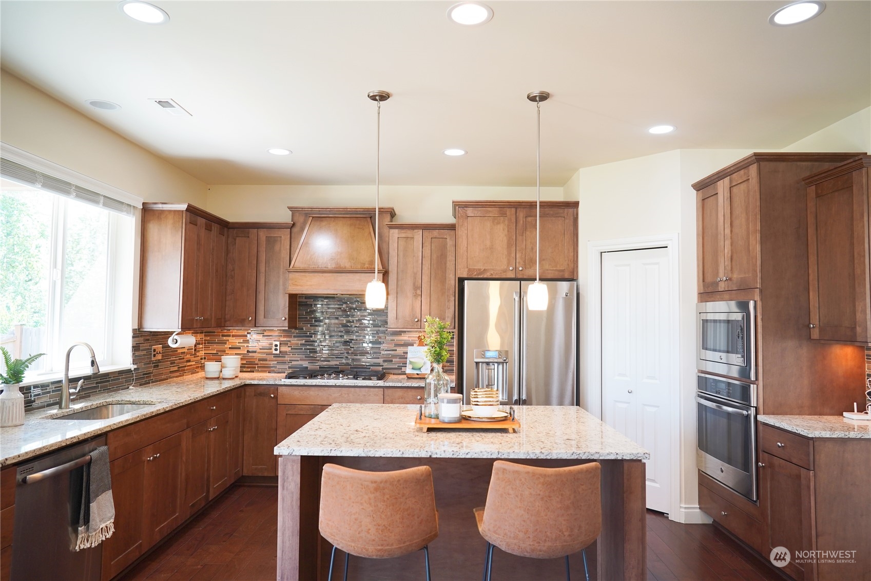 13763 173rd Place Southeast Renton, WA 98059 - Photo 11 of 40 a kitchen with stainless steel appliances granite countertop a sink refrigerator and cabinets