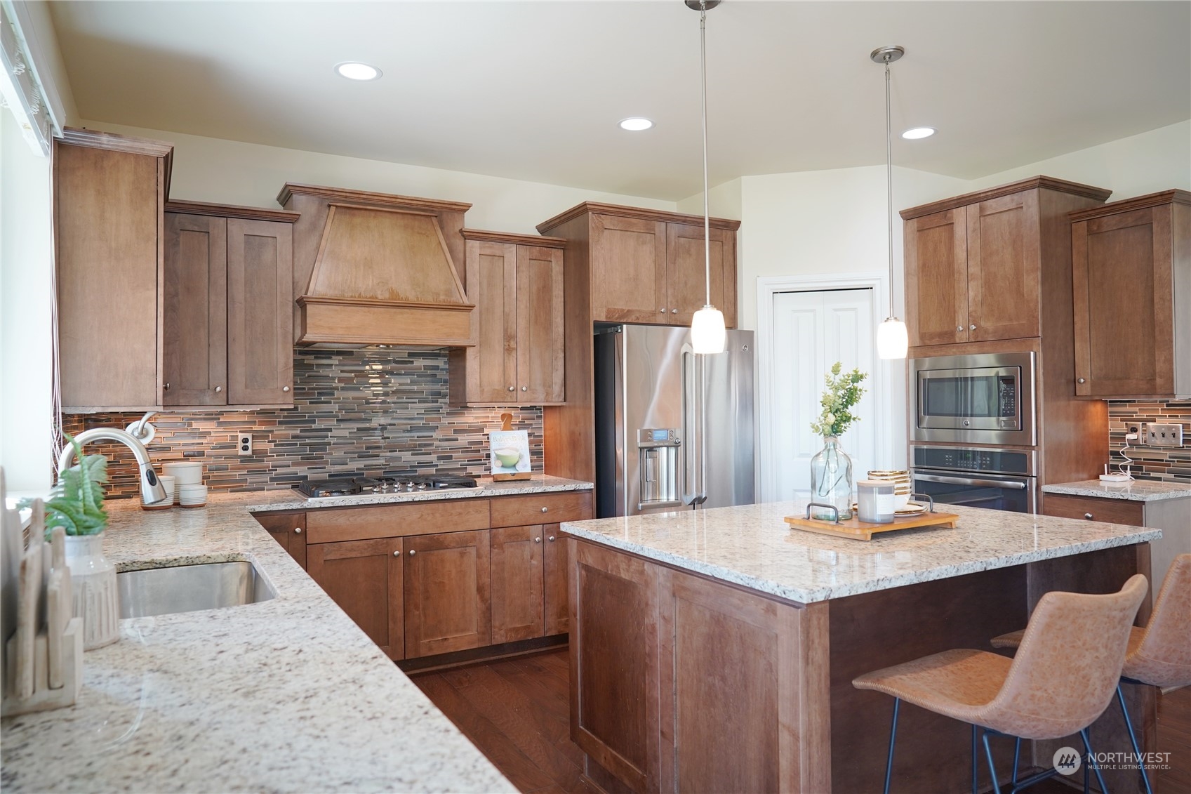 13763 173rd Place Southeast Renton, WA 98059 - Photo 13 of 40 a kitchen with stainless steel appliances granite countertop a sink refrigerator and cabinets