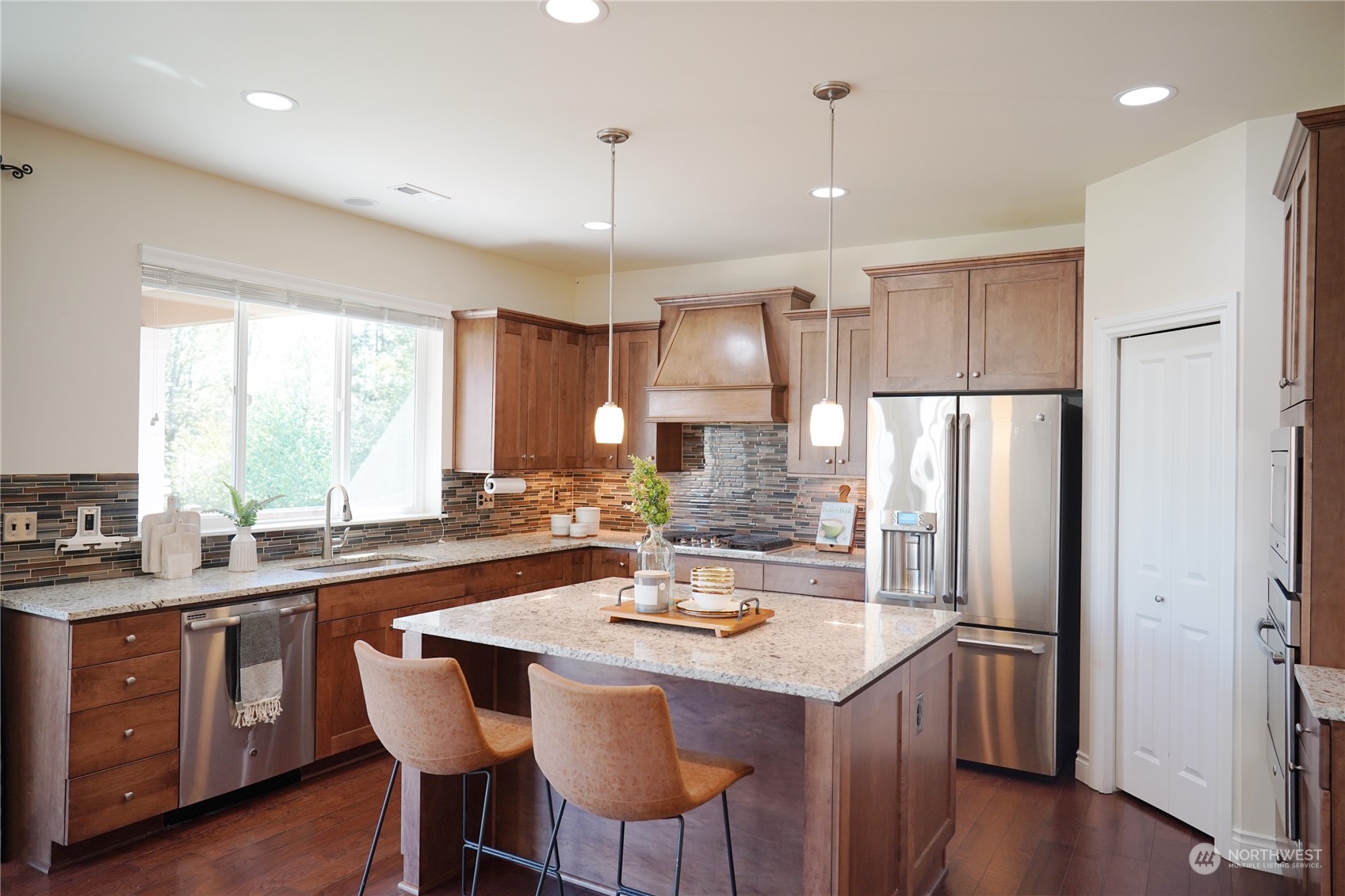 13763 173rd Place Southeast Renton, WA 98059 - Photo 14 of 40 a kitchen with refrigerator a sink and chairs