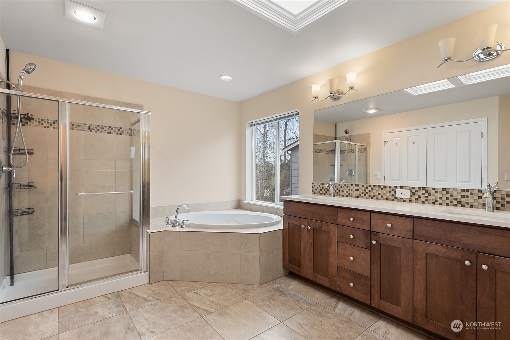 13763 173rd Place Southeast Renton, WA 98059 - Photo 26 of 40 a spacious bathroom with a shower a sink and mirror