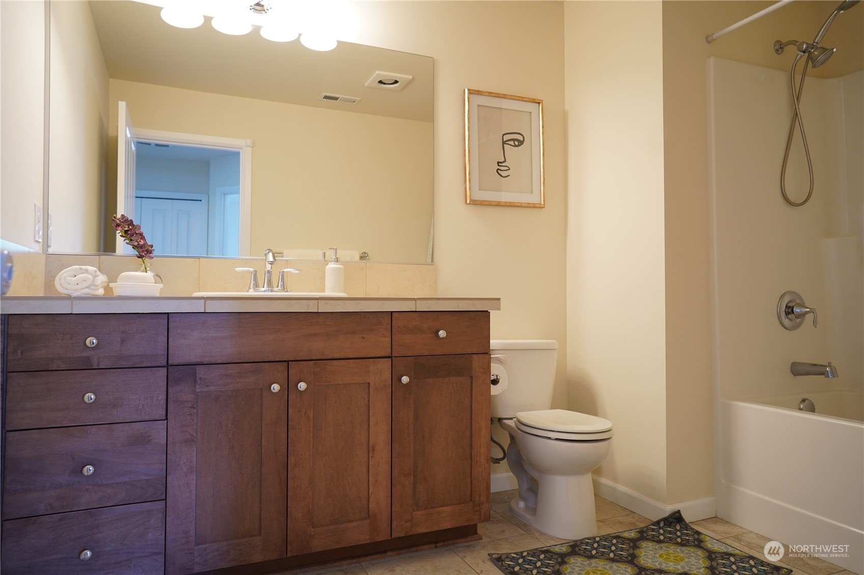13763 173rd Place Southeast Renton, WA 98059 - Photo 29 of 40 a bathroom with a double vanity sink toilet and shower