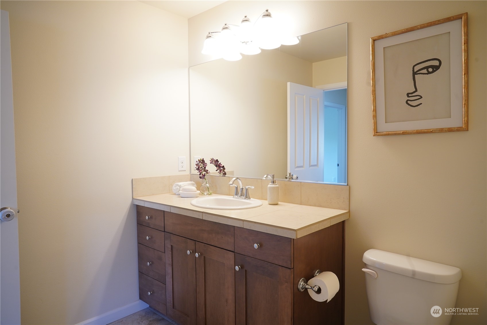 13763 173rd Place Southeast Renton, WA 98059 - Photo 30 of 40 a bathroom with a toilet sink vanity and mirror