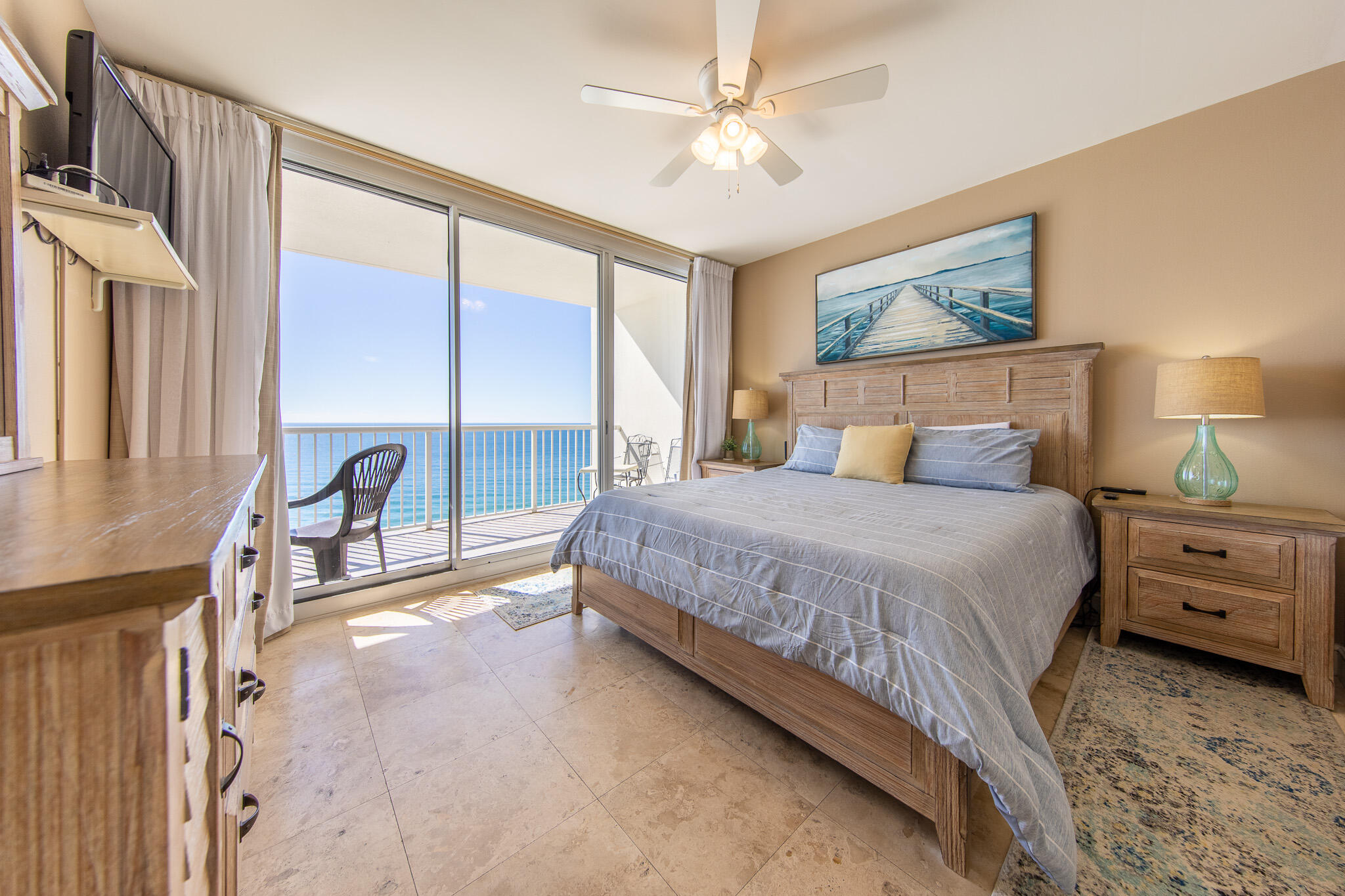 10901 Front Beach Road, Unit 2103 Panama City Beach, FL 32408 - Photo 1 of 54 a bedroom with a large bed and a chandelier